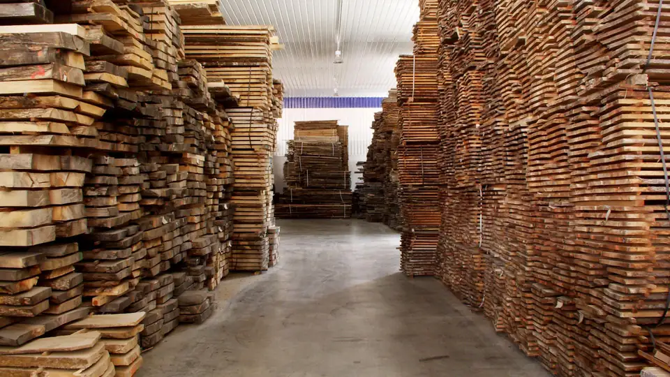 Stacks of seasoned timber boards in a storage hall
