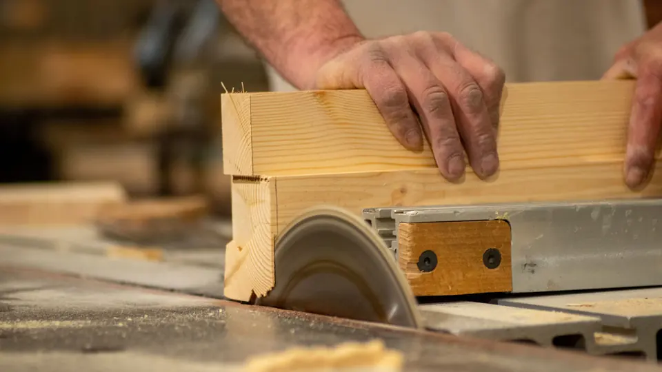 A circular saw cutting a timber board